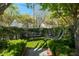 Serene backyard featuring a lush lawn, manicured hedges, and comfortable outdoor seating at 56 Parkwood Ave, Charleston, SC 29403