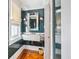 Well-lit powder room with a marble sink, patterned wood floor, and designer finishes at 56 Parkwood Ave, Charleston, SC 29403
