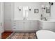 Spacious bathroom featuring double vanity with marble countertops, wood floors and contemporary lighting at 56 Parkwood Ave, Charleston, SC 29403