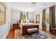 Cozy bedroom features a plush rug, natural light, and a neutral color palette, creating a relaxing atmosphere at 56 Parkwood Ave, Charleston, SC 29403
