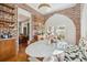 Dining room boasts exposed brick, marble table, built in bench seating and shelves for storage at 56 Parkwood Ave, Charleston, SC 29403