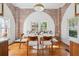 Bright dining area featuring hardwood floors, an arched brick wall, and stylish seating at 56 Parkwood Ave, Charleston, SC 29403