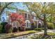 Elegant brick home with black shutters, arched entryway, and beautiful landscaping at 56 Parkwood Ave, Charleston, SC 29403