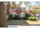 Charming brick home featuring a well-manicured lawn and lush landscaping at 56 Parkwood Ave, Charleston, SC 29403