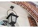 Close up of the entrance featuring a brick archway and an ornate vintage outdoor light fixture at 56 Parkwood Ave, Charleston, SC 29403