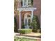 Inviting front entrance with a classic brick facade, columns, and manicured landscaping at 56 Parkwood Ave, Charleston, SC 29403