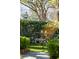 Landscaped garden featuring an outdoor seating area surrounded by manicured greenery and mature trees at 56 Parkwood Ave, Charleston, SC 29403