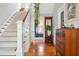Inviting hallway with hardwood floors, a staircase, and stylish furnishings at 56 Parkwood Ave, Charleston, SC 29403