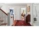 Hallway featuring hardwood floors and openings to multiple rooms, including a bedroom and bath at 56 Parkwood Ave, Charleston, SC 29403