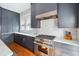 The updated kitchen boasts stainless steel appliances, sleek cabinetry, and marble countertops at 56 Parkwood Ave, Charleston, SC 29403