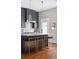 This kitchen features an eat in island with seating, marble countertops and stainless steel fixtures at 56 Parkwood Ave, Charleston, SC 29403