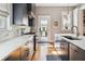The renovated kitchen features granite counters, stainless appliances, and access to the outdoor living space at 56 Parkwood Ave, Charleston, SC 29403