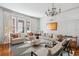 Bright living room featuring a decorative chandelier and plush seating for relaxing and entertaining at 56 Parkwood Ave, Charleston, SC 29403