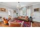 Cozy living room features hardwood floors, neutral paint, and elegant seating, bathed in natural light at 56 Parkwood Ave, Charleston, SC 29403