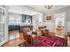 Open-concept living room leads to kitchen and dining area, complemented by hardwood floors and natural light at 56 Parkwood Ave, Charleston, SC 29403