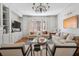 A cozy living room with built-in shelving, a modern chandelier, and large windows providing natural light at 56 Parkwood Ave, Charleston, SC 29403