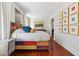 Spacious main bedroom with hardwood floors, bright windows, and unique colorful furnishings at 56 Parkwood Ave, Charleston, SC 29403