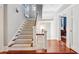 Bright stairway with carpeted steps, white railings, and wood floors leading to upper level at 56 Parkwood Ave, Charleston, SC 29403
