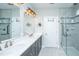 Well-lit bathroom boasts double vanity, large mirror, and glass-enclosed shower at 566 Four Seasons Blvd, Summerville, SC 29486