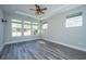 Bright bedroom with hardwood floors, ceiling fan, and large windows at 566 Four Seasons Blvd, Summerville, SC 29486