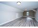Large bonus room with log cabin accent wall and hard surface flooring at 566 Four Seasons Blvd, Summerville, SC 29486