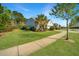 Well-maintained home with a green lawn, palm tree, and a concrete walkway leading to the entrance at 566 Four Seasons Blvd, Summerville, SC 29486