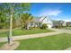 Charming single-story home with a well-manicured lawn, palm tree, and inviting curb appeal at 566 Four Seasons Blvd, Summerville, SC 29486