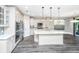 Bright kitchen with stainless appliances, large island, and pendant lighting above a marble countertop at 566 Four Seasons Blvd, Summerville, SC 29486