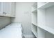 Functional laundry area with modern appliances, built-in shelving, and storage cabinets at 566 Four Seasons Blvd, Summerville, SC 29486