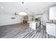 Open-concept living room flows into the kitchen, features stylish floors and modern lighting at 566 Four Seasons Blvd, Summerville, SC 29486