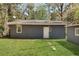 Exterior of home features a grass lawn with a pathway leading to back door at 5729 Edison Ave, Hanahan, SC 29410