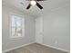 Comfortable bedroom with a ceiling fan, gray flooring, and a window at 5729 Edison Ave, Hanahan, SC 29410