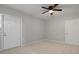 Bedroom with tiled floors, ceiling fan, and two entry doors at 5729 Edison Ave, Hanahan, SC 29410