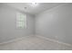 Bright bedroom features tile floors, a window, and neutral walls at 5729 Edison Ave, Hanahan, SC 29410