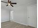 Bedroom featuring gray floors, a fan, and multiple entryways at 5729 Edison Ave, Hanahan, SC 29410