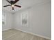 Bright bedroom features gray floors, neutral walls, and a ceiling fan at 5729 Edison Ave, Hanahan, SC 29410