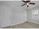 Bedroom with gray floors, a ceiling fan, and a large closet at 5729 Edison Ave, Hanahan, SC 29410