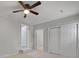Bedroom with tiled floor, a ceiling fan, and multiple closets for ample storage at 5729 Edison Ave, Hanahan, SC 29410