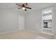 Bedroom with tiled floors, a ceiling fan, and an open doorway to the kitchen at 5729 Edison Ave, Hanahan, SC 29410