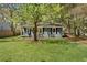 Inviting home showcasing a lush green lawn and mature trees, offering a serene and picturesque setting at 5729 Edison Ave, Hanahan, SC 29410