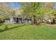 Beautifully maintained home with spacious front yard and inviting landscaping, including a detached garage at 5729 Edison Ave, Hanahan, SC 29410