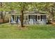 Charming home with gray siding and dark shutters, complemented by a well-manicured lawn at 5729 Edison Ave, Hanahan, SC 29410