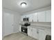 This kitchen features white cabinets, stainless steel appliances, and granite countertops at 5729 Edison Ave, Hanahan, SC 29410
