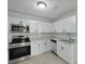 Updated kitchen with stainless steel appliances, white cabinetry, and modern countertops at 5729 Edison Ave, Hanahan, SC 29410