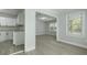 Bright living room with light grey flooring and light grey walls open to the kitchen at 5729 Edison Ave, Hanahan, SC 29410