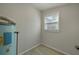 Utility room with beadboard walls, vinyl flooring, and a window for natural light at 5729 Edison Ave, Hanahan, SC 29410