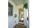 Charming entrance with wooden door, fern, and silver mailbox, offering curb appeal and a welcoming touch to the home at 7 Fields Pl, Charleston, SC 29403