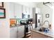 Well-lit kitchen with stainless steel appliances, granite countertops, light gray cabinets, and a modern sink at 7 Fields Pl, Charleston, SC 29403