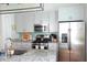 Bright kitchen with gray cabinets, stainless steel appliances, granite countertops, and modern lighting at 7 Fields Pl, Charleston, SC 29403