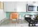 A close-up of a kitchen featuring stainless steel appliances, granite countertops, and a modern backsplash at 7 Fields Pl, Charleston, SC 29403